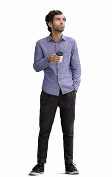 young man in full growth. isolated on white background. holding a mug of coffee.