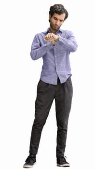 young man in full growth. isolated on white background looking at wristwatch.