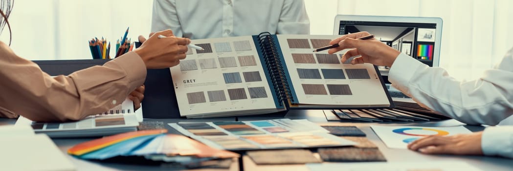 Group of interior designer team in meeting, discussing with engineer on interior design and planning for house project blueprint and model, choosing various mood board materials. Insight