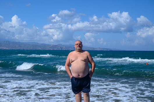 a man emerges from the Mediterranean sea on a sunny day