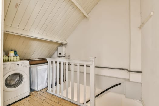 a laundry room with a washer, dryer and washing machine in the corner on the right hand side