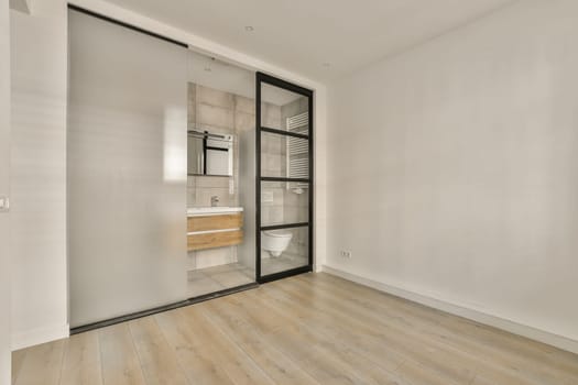 an empty room with wood flooring and white paint on the walls, there is a mirror in the door