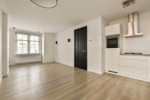 an empty living room with wood flooring and white walls in the room is well lit by the light coming through the window