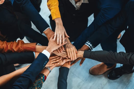 A group of diversity people putting their hands together. Showing unity teamwork and friendship. Close up top view of young business man and business woman joining as a team. Intellectual.