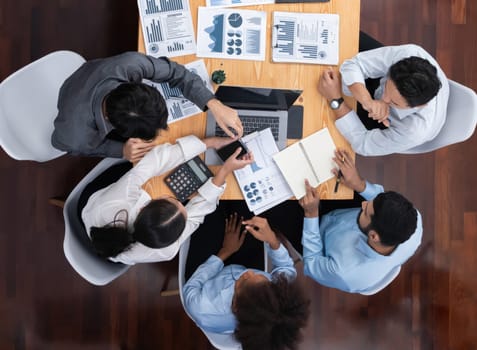 Top view multiracial analyst team use BI dashboard display on laptop screen, analyzing financial data for strategic decision. Fintech analyzes marketing indicators. Concord