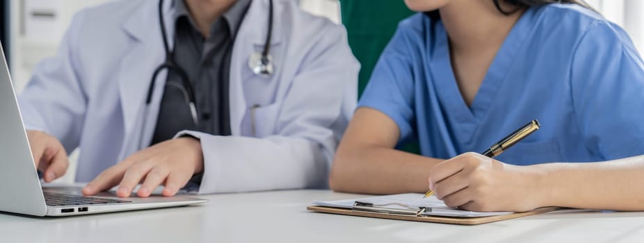 Professional various team of medical working and planning medical treatment at hospital table together. Teamwork lead to successful illness and sickness treatment. Panorama Rigid