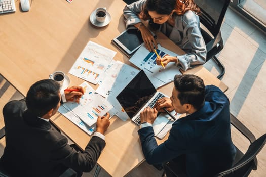 Business people group meeting shot from top view in office . Profession businesswomen, businessmen and office workers working in team conference with project planning document on meeting table . Jivy