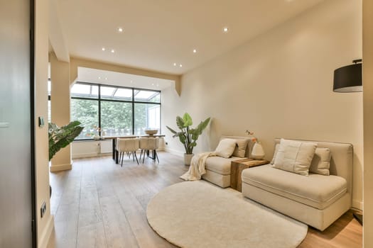 a living room with a couch, chair and coffee table on the floor in front of an open glass door