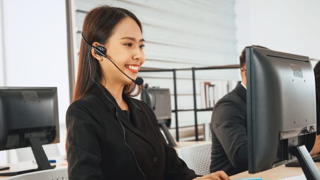 Business people wearing headset working in office to support remote customer or colleague. Call center, telemarketing, customer support agent provide service on telephone video conference call. Jivy