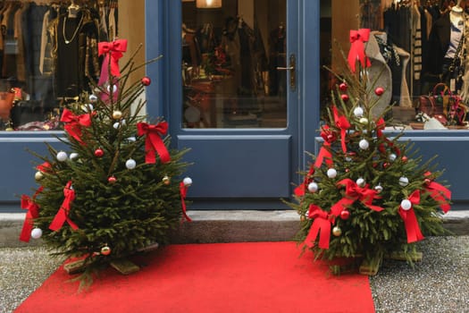 The store facade is decorated with Christmas trees.