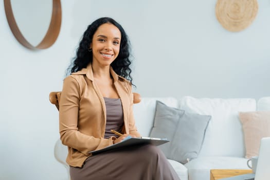 Psychologist woman in clinic office professional portrait with friendly smile feeling inviting for patient to visit the psychologist. The experienced and confident psychologist is crucial specialist