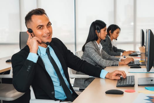 Business people wearing headset working in office to support remote customer or colleague. Call center, telemarketing, customer support agent provide service on telephone video conference call. Jivy