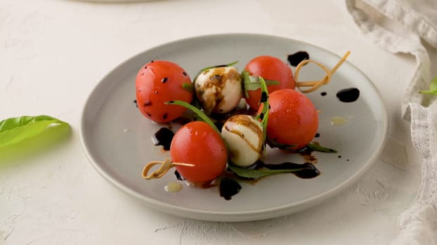 Healthy appetizer - caprese salad with tomato and mozzarella, italian food of mediterranean diet with olive oil dressing, weight loss concept