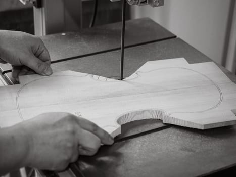 violin maker sawing a classical italian violin top plate