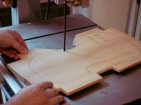 violin maker sawing a classical italian violin top plate