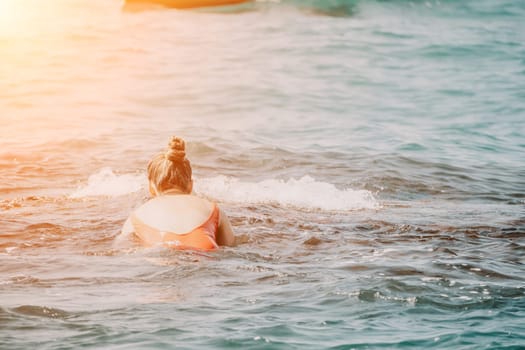 Woman sea yoga. Back view of free calm happy satisfied woman with long hair standing on top rock with yoga position against of sky by the sea. Healthy lifestyle outdoors in nature, fitness concept.