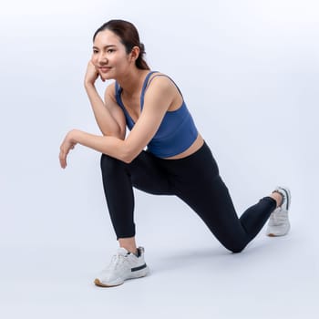 Young attractive asian woman in sportswear stretching before fitness exercise routine. Healthy body care workout with athletic woman warming up on studio shot isolated background. Vigorous