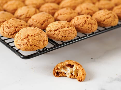 Amaretti cookie on cooling rack - traditional Italian Sardinian pastry. Delicious amaretti biscuit cookies made from almond or apricot kernels with copy space