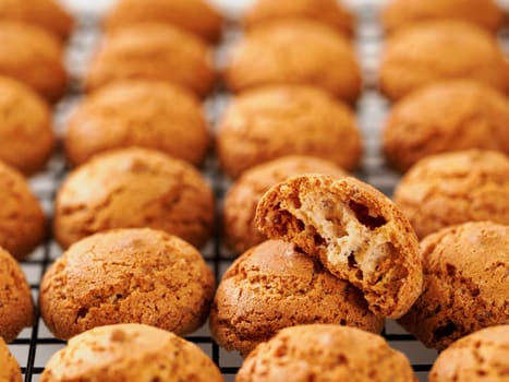Amaretti cookie on cooling rack - traditional Italian Sardinian pastry. Delicious amaretti biscuit cookies made from almond or apricot kernels with copy space