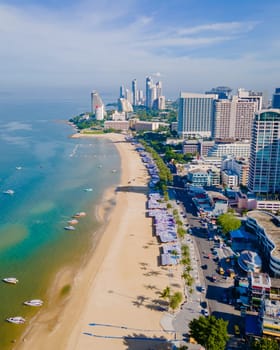 Pattaya Thailand, a view of the beach road with hotels and skyscrapers buildings alongside the renovated new beach road. Drone aerial view of the beach of Pattaya