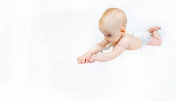 a baby with a hemangioma on his neck lies on a white background. banner with a copy space. profile of a little bald baby girl. the kid looks to the side