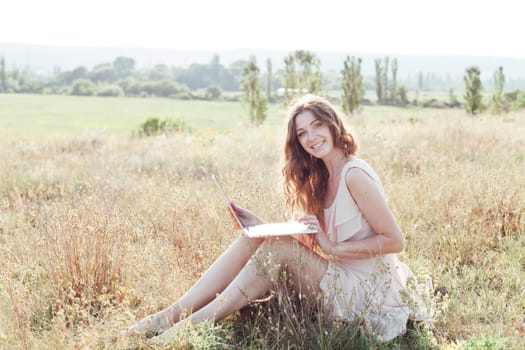 a woman with laptop in nature leisure walk travel communication
