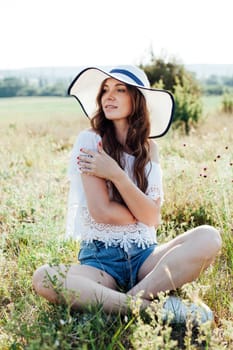 portert of beautiful woman in a hat in nature