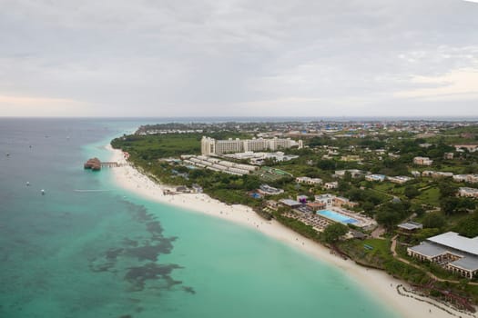 Awesome aerial view of coastline and turquoise ocean in zanzibar at cloudy day, tanzania.