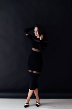 a fashionable brunette woman on a black background