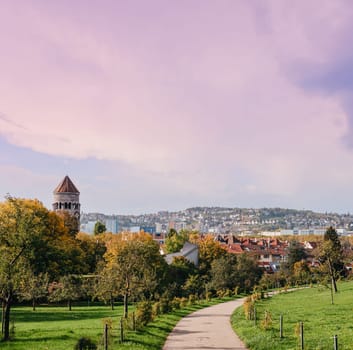 Germany, Stuttgart panorama view. Beautiful houses in autumn, Sky and nature landscape. Vineyards in Stuttgart - colorful wine growing region in the south of Germany with view over Neckar Valley. Germany, Stuttgart city panorama view above vineyards, industry, houses, streets, stadium and highway at sunset in warm orange light.