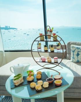 afternoon tea or high tea in a hotel room with bright fresh colors, a minimal style bedroom with an ocean view