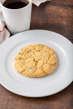 Bitter almond cookies or turkish name acibadem kurabiyesi with coffee on wooden table