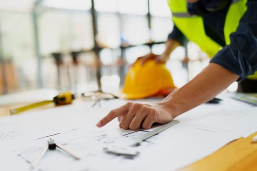 engineers discuss building on blueprint drawing, design building Project in office