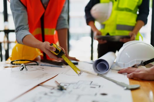 engineers discuss building on blueprint drawing, design building Project in office