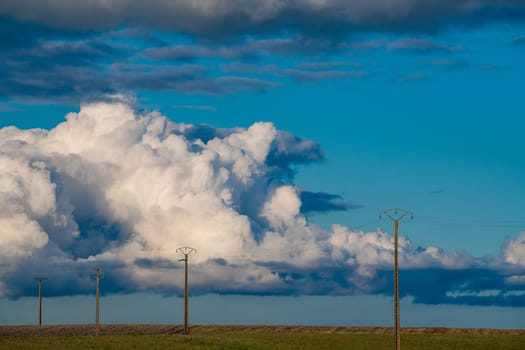 Power line on landscape background Ornamental clouds, dramatic sky, epic storm landscape. High quality photo