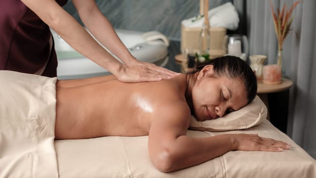 Asian Thai woman getting a Thai massage in a Massage room in Thailand at a luxury hotel spa
