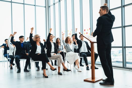 Group of business people meeting in a seminar conference . Audience listening to instructor in employee education training session . Office worker community summit forum with expert speaker . Jivy