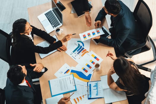 Business people group meeting shot from top view in office . Profession businesswomen, businessmen and office workers working in team conference with project planning document on meeting table . Jivy