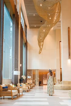 a Asian woman in a hotel lobby of a luxury hotel in Thailand