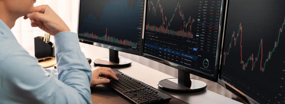 Stock trading investor monitoring dynamic financial data graph for profitable trade. Businessman or broker with analytic thinking analyzing data for stock market exchange trading company. Trailblazing