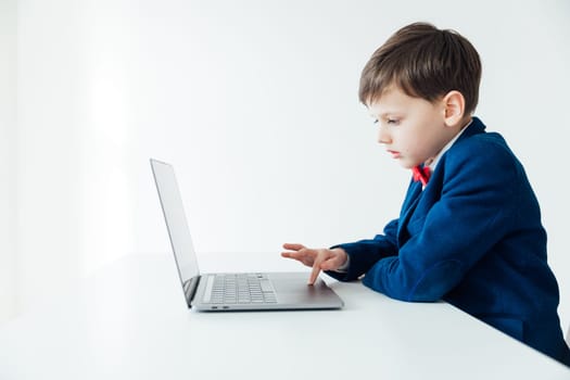 a school IT programming boy at the computer in the classroom learning online