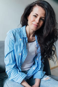 woman in blue jeans sitting on a chair