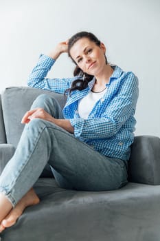 woman in blue jeans sitting on a chair