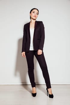 business woman at work in office stands in a business suit