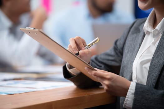 Analyst team writing and planning marketing using BI dashboard data to analyze financial report on meeting table. Business people utilize data analysis by FIntech for business decision. Concord