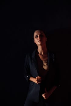 woman in a business suit dark room in a room on a black background
