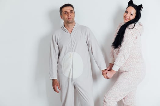 a husband and wife man and woman in love in pajamas in the morning in a bright room