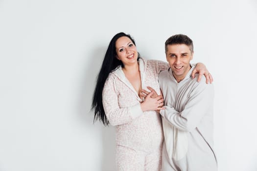 a husband and wife man and woman in love in pajamas in the morning in a bright room
