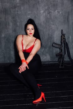 a woman with tied hands in a dark room basement weapon