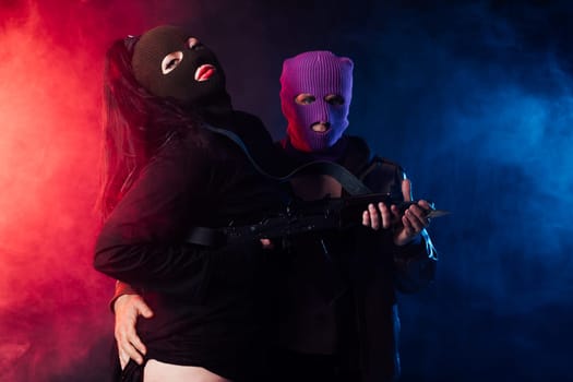 man and a woman with their faces covered in a dark room on a black background